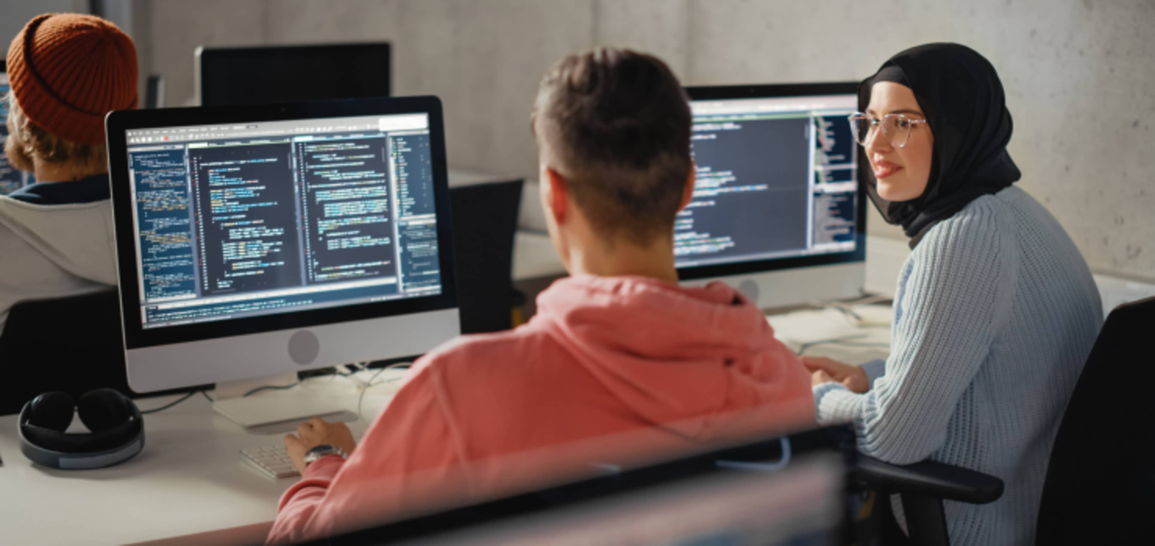two international students doing computer codes