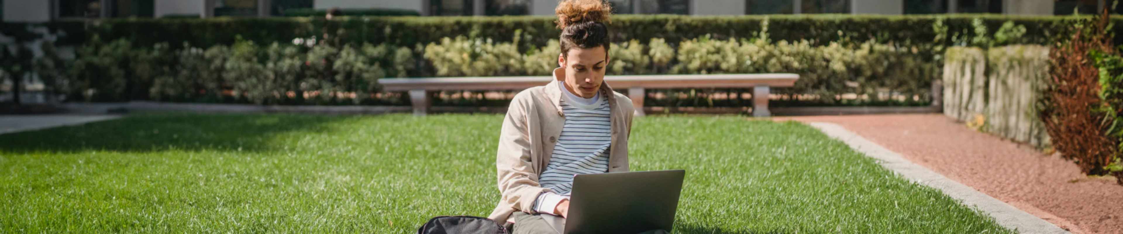 Student using his laptop in a park