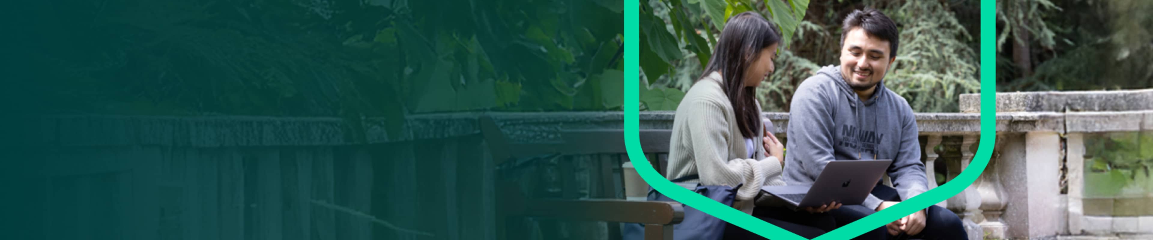 Two Exeter students sitting together on bench