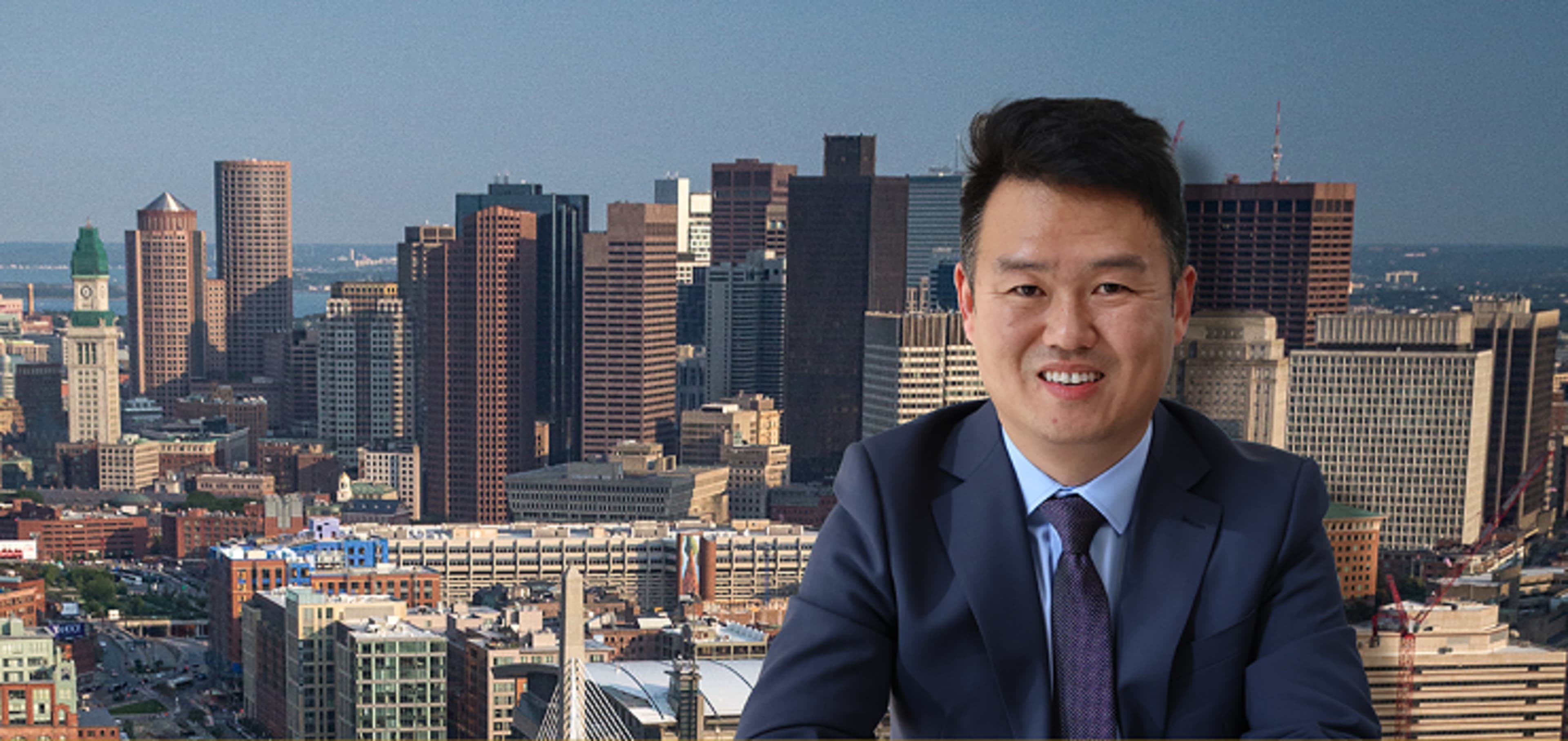 Student smiling at the camera with the city as background