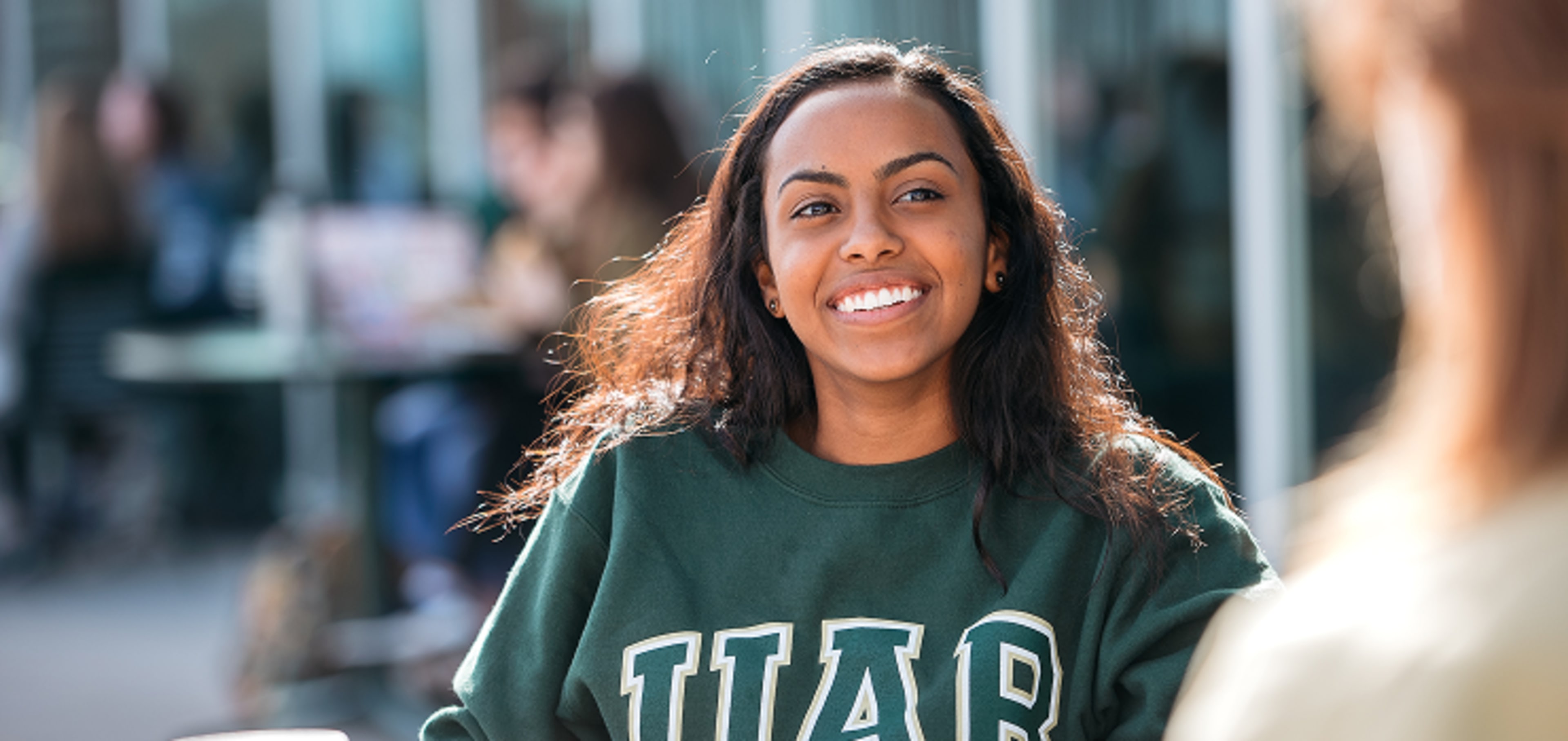 A student smiling to the camera